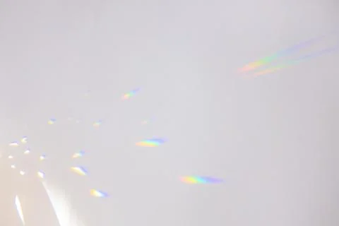 Bright iridescent highlights on a neutral gray background. Stock Photos