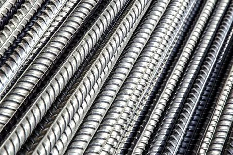 Bright iron grunge background: glittering new clean reinforcement bars, short Stock Photos