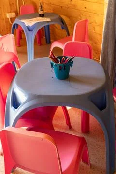 Bright Kids Creative Workspace with Plastic Tables and Pink Chairs Stock Photos