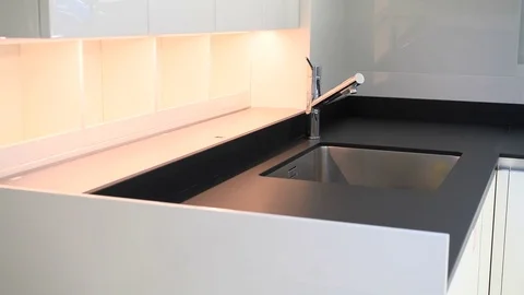 Bright kitchen with black counter on a super yacht Stock Footage 71834236