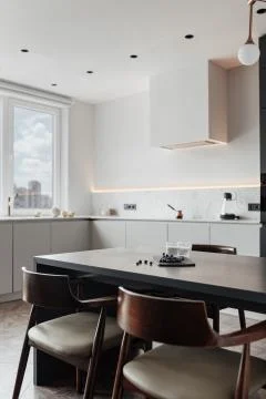 Bright kitchen with dark table, convenient location of kitchen accessories and Stock Photos