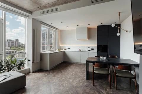 Bright kitchen with dark table, convenient location of kitchen accessories and Stock Photos