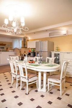 Bright kitchen with a dining area. stylish table and chairs in the room Stock Photos