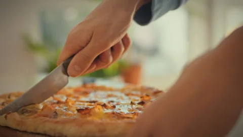 In a bright kitchen a housewifes skilled hands carefully slice a homemade pi Stock Footage 331866623