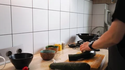 Bright kitchen setting filled with fresh vegetables on a wooden countertop. A Stockbeeldmateriaal 316479224