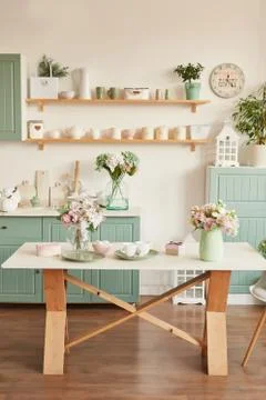 Bright kitchen in the style of Provence, on the table dishes and a bouquet of fl Stock Photos