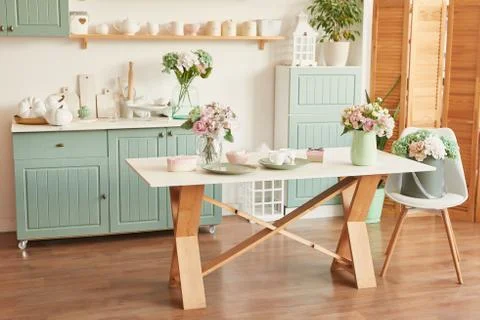Bright kitchen in the style of Provence, on the table dishes and a bouquet of fl Stock Photos