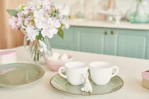 Bright kitchen in the style of Provence, on the table dishes and a bouquet of fl Stock Photos