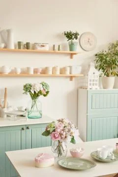 Bright kitchen in the style of Provence, on the table dishes and a bouquet of Stock Photos
