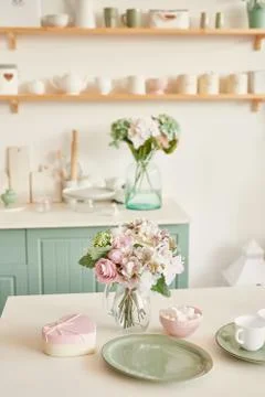 Bright kitchen in the style of Provence, on the table dishes and a bouquet of Stock Photos