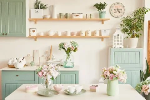 Bright kitchen in the style of Provence, on the table dishes and a bouquet of Stock Photos