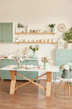 Bright kitchen in the style of Provence, on the table dishes and a bouquet of Stock Photos