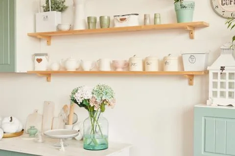 Bright kitchen in the style of Provence, on the table dishes and a bouquet of Stock Photos
