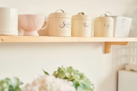 Bright kitchen in the style of Provence, on the table dishes and a bouquet of fl Stock Photos