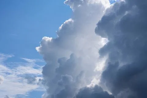 Bright landscape of white and dark fluffy cumulus clouds in a clear blue sky Stock Photos