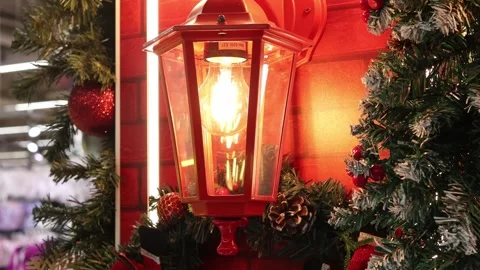 Bright lantern illuminates festive decorations in a cozy holiday setting Stock-Footage 296145478