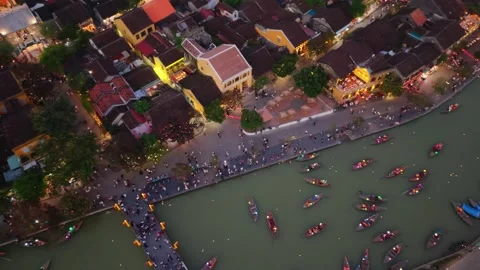 Bright Lanterns Illuminate Bustling Riverside Walk. Lanternlit Vessels Drift Stock Footage 342921024