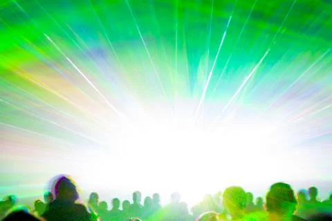 Bright laser show rays stream. Very colorful show with a crowd silhouette and Stock Photos