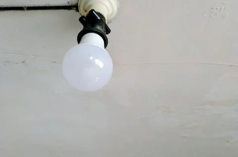 Bright LED bulb illuminates clean ceiling,modern lighting solution for any space Stock Photos