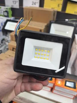 Bright LED light fixture held in hand at local hardware store Stock-Fotos