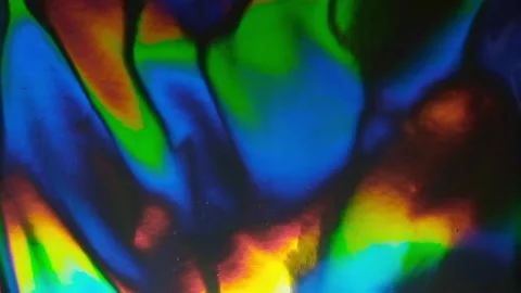 Bright led light moving over silver rainbow holofoil. Stock Footage 234116317