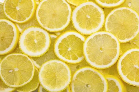 Bright lemon background. Lemon slices full frame. Stock Photos