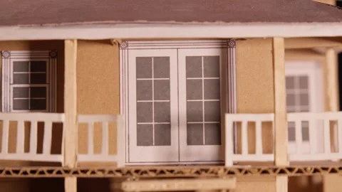 Bright light and shadow on cardboard maquette house dark background and lighting Stock Footage 259366894