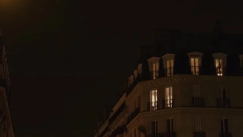 A bright light beam sweeps across the winter sky over Paris rooftops Stock Footage 320990705