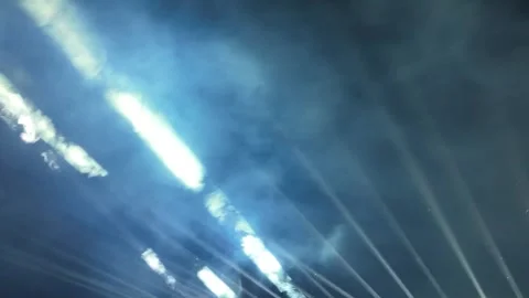 Bright Light Beams Piercing Through Smoke in the Night Sky. Professional Stage Stockbeeldmateriaal 334040203