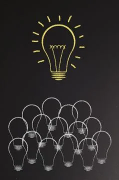 Bright light bulb on blackboard Stock Illustration