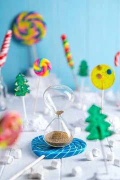 A bright light composition of multi-colored lollipops. hourglass, New Year, C Stock Photos
