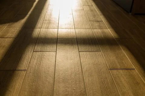 Bright light enters through windows and casts dark shadows on the floor Stock Photos