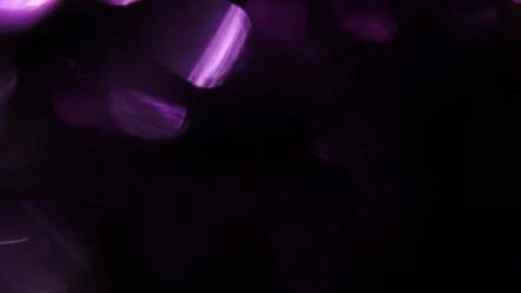 Bright light leak, purple sparkling bokeh on the left in the black 스톡 동영상 318945894