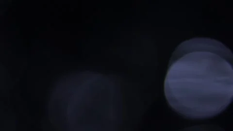 Bright light leaks make large blue bokeh in motion in the dark Видео 318918945