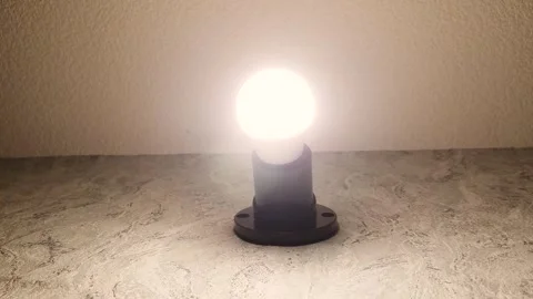 Bright light from LED light bulb indoors. LED light bulb is wall Stock Footage 269186716
