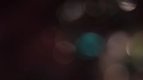 Bright light shines in the dark as a multi-colored bokeh. Vídeo Stock 319392045