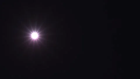 Bright light shining in a dark background with star-like Stock Footage 338043363