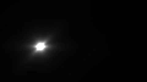 Bright light shining in dark sky during nighttime Stock Footage 338179828