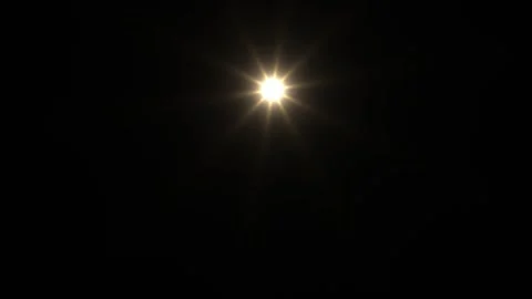 Bright light shining in darkness creating star effect Stock Footage 338318001