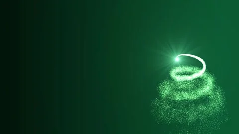 A bright light source draws a Christmas tree made of green particles on a green Stock Footage 257184097