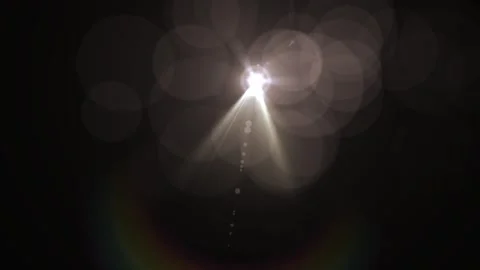 Bright Light Source with Dynamic Lens Flare and Bokeh Effect in Dark Background Stock Footage 337954880