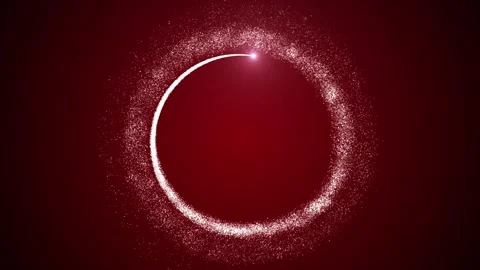 A bright light source flies in a circle, leaving a trail of particles on a red Stock Footage 256093315
