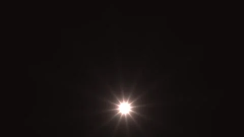 Bright light source shining in dark background creating Stock Footage 338289030