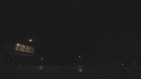 Bright lightning bolts flash over a road on a stormy night Stock Footage 337854153