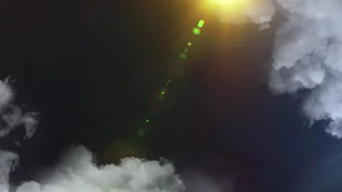 Bright lightning bolts striking through dark clouds with radiant sun flare Video stock 343840575