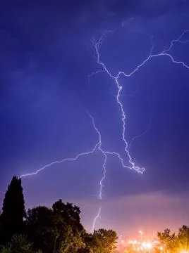 Bright lightning sparkles with a beautiful pattern in the evening sky Stock Photos