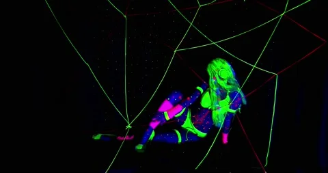 Bright lights and glowing strings in uv light, woman is glowing and posing, 4k Stock Footage 136355786