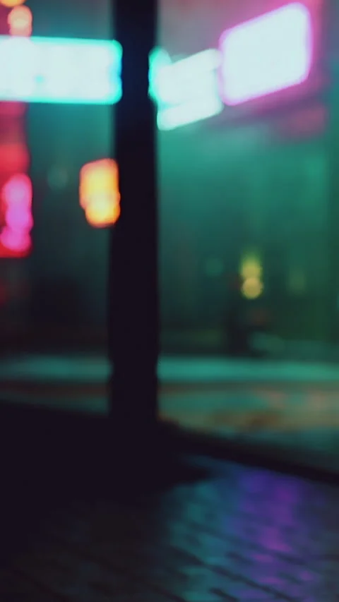 Bright lights and reflections at night on a busy city street scene Stock Footage 339417737