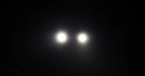 Bright lights appear in the night sky over a quiet neighborhood Stock Footage 281704583