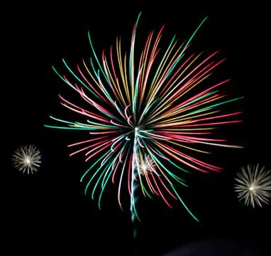 Bright lights of firework in dark night sky. Stock Photos